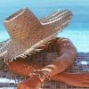 Woman In Swimming Pool In A Large Beige Sunhat